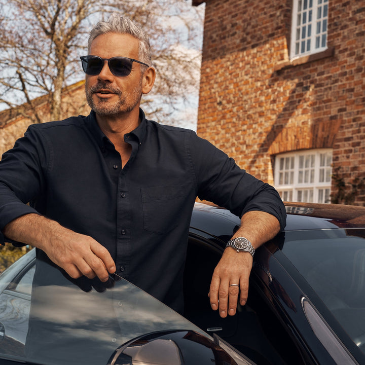 Cestrian Master Series CM-BK001 outdoor lifestyle portrait of a model wearing a steel bracelet watch leaning against car
