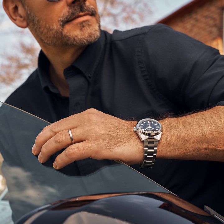 Cestrian Master Series CM-BK001 on-wrist lifestyle profile showing a black dial automatic watch on a car window frame