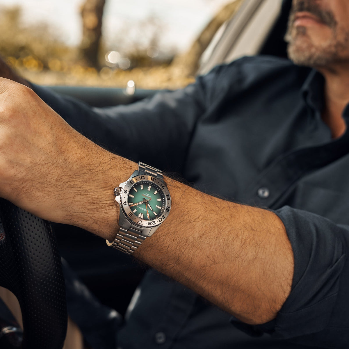 Cestrian Ocean Series CO-BGS001 lifestyle shot of watch with green fumé dial worn on wrist while holding steering wheel