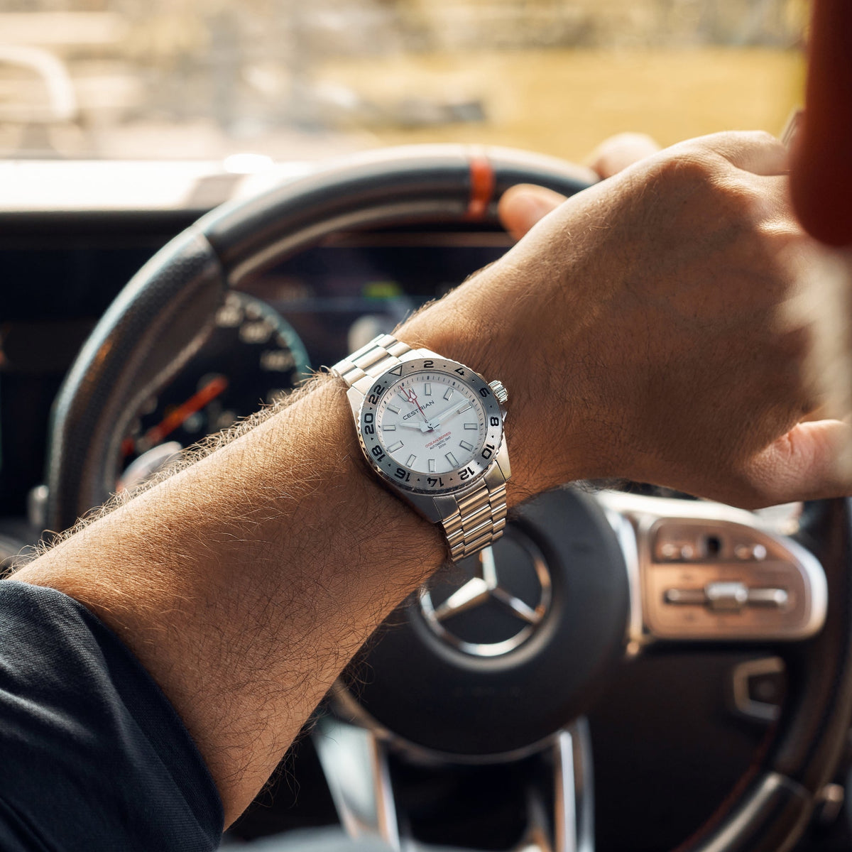 Cestrian Ocean Series CO-SWS001 lifestyle shot of watch with silver white dial worn on wrist while holding steering wheel